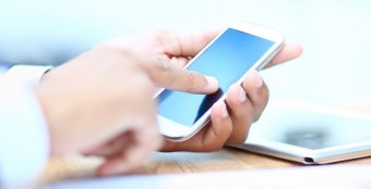 Close up of a man using mobile smart phone